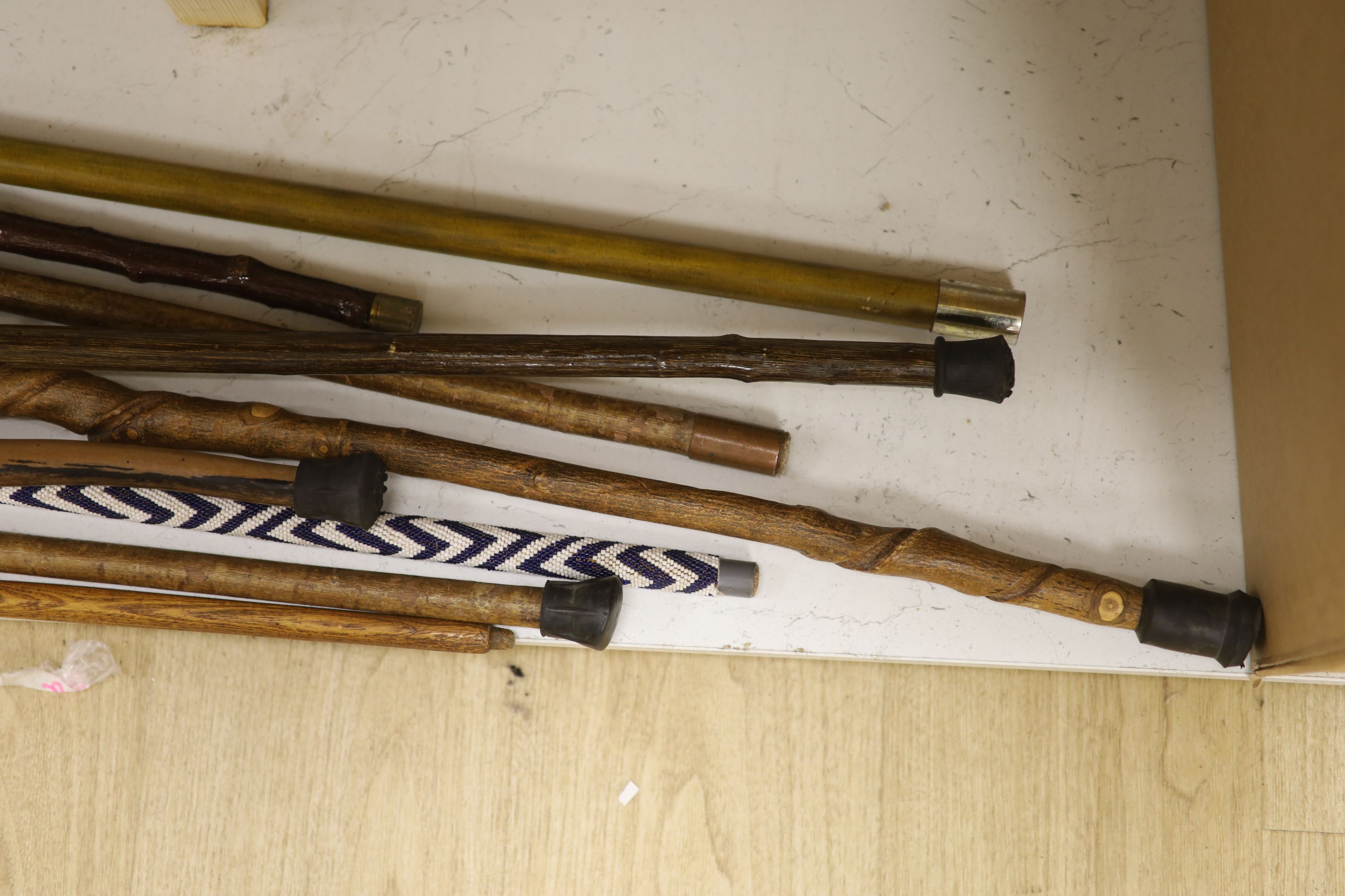 A collection of nine various handled walking sticks